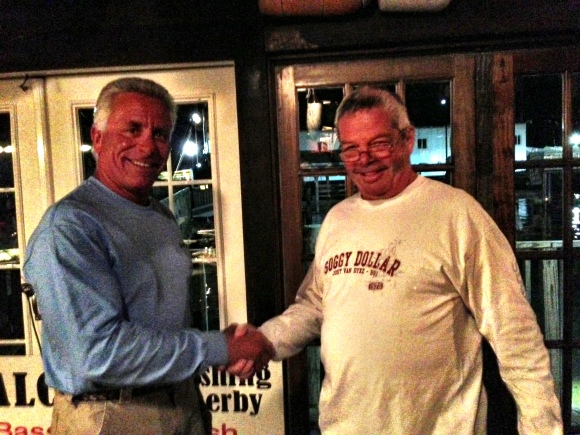 Don Estes awards Dave P the prize for largest striper and blue fish in the Calcutta Fishing Derby